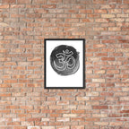 Framed artwork with Om symbol on a brick wall